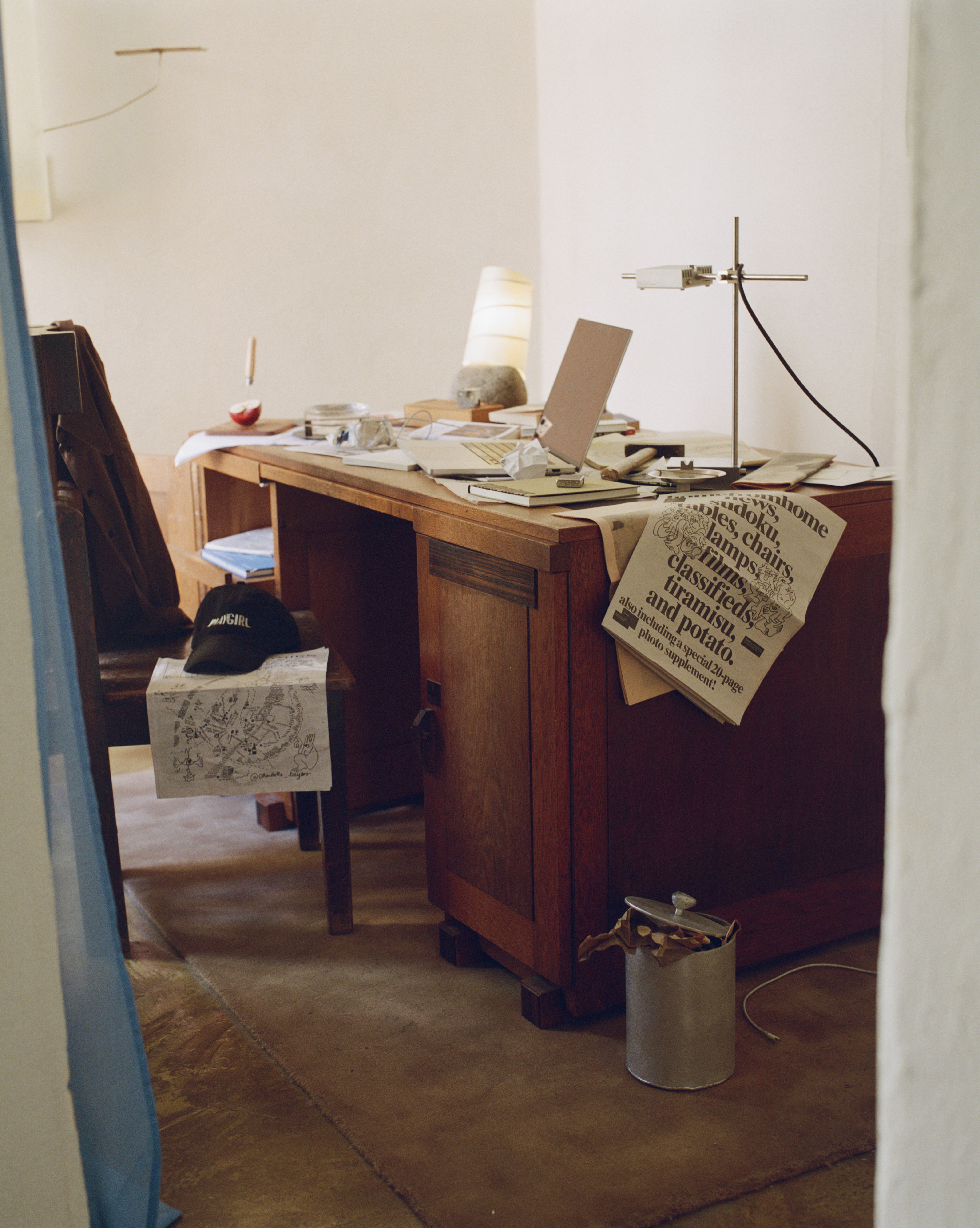 A series of messy interiors, with wooden furniture covered in piles of printed matter, collectibles, leftover food and crockery, and more.