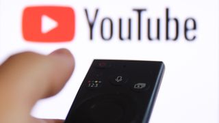 A TV remote pointing at YouTube logo