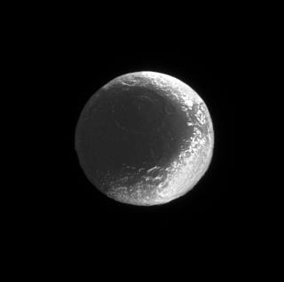 The contrast of the light and dark surface of Iapetus is prevalent in this image. The right side is much lighter than the left.