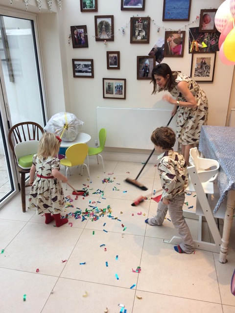 Dolly Jones and her children wear matching outfits while tidying up Christmas mess