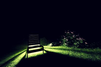 Lawn At Night With A Light Shining Through A Lawn Chair