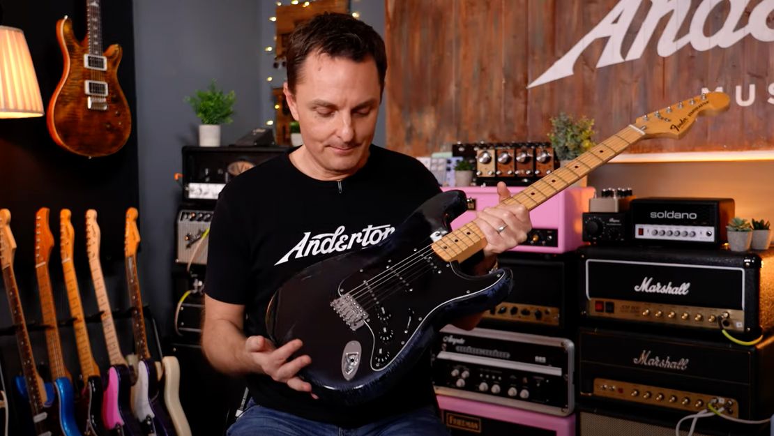 Lee Anderton holding a 1979 Fender Stratocaster guitar