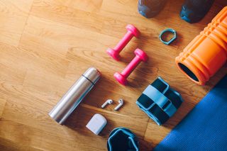 Home gym kit arranged on a wooden floor