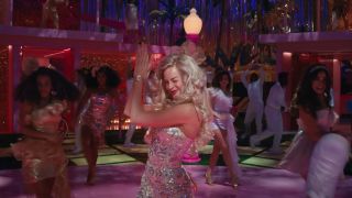Margot Robbie dancing and clapping in Barbie