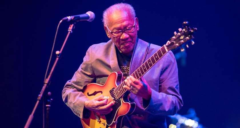 Ska and reggae pioneer Ernest Ranglin plays his Gibson semi-hollow onstage in 2016.