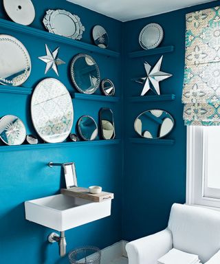 blue bathroom with mirror wall display