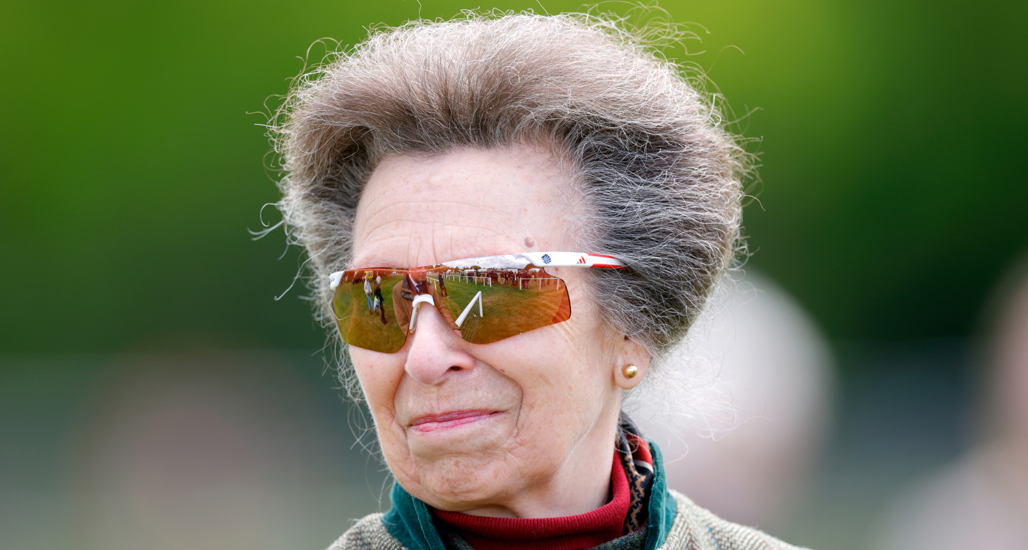 Princess Anne smiling in a pair of sunglasses
