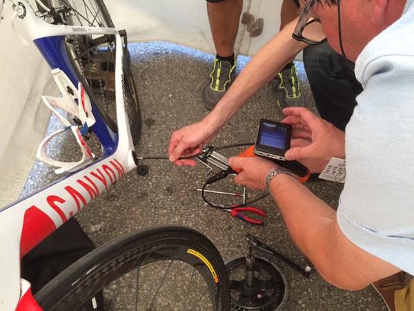 UCI officials check bikes for motors after stage 18 at the Tour de France