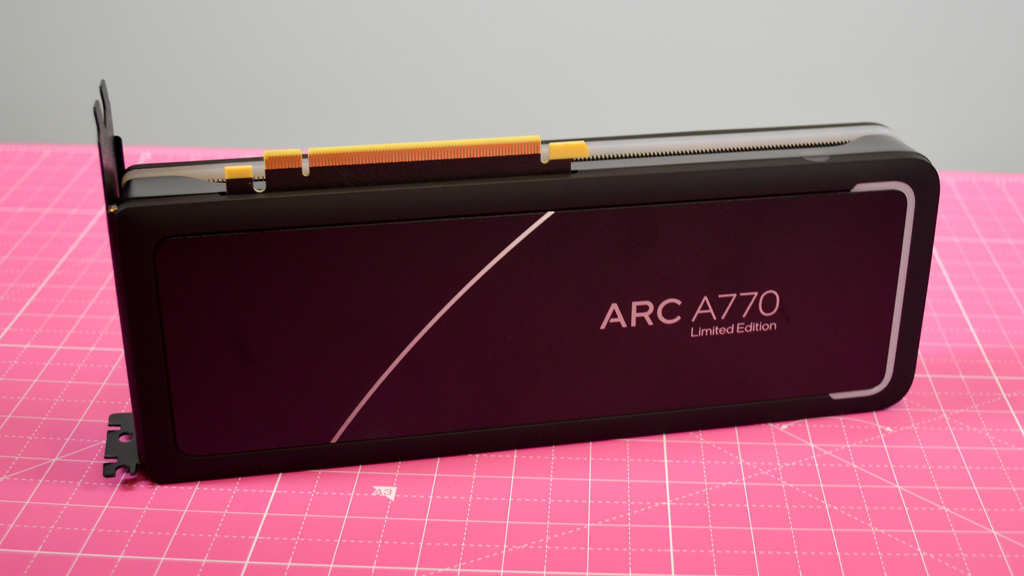An Intel Arc A770 LE graphics card on a table with a pink desk mat