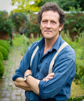 monty don with his arms crossed in garden