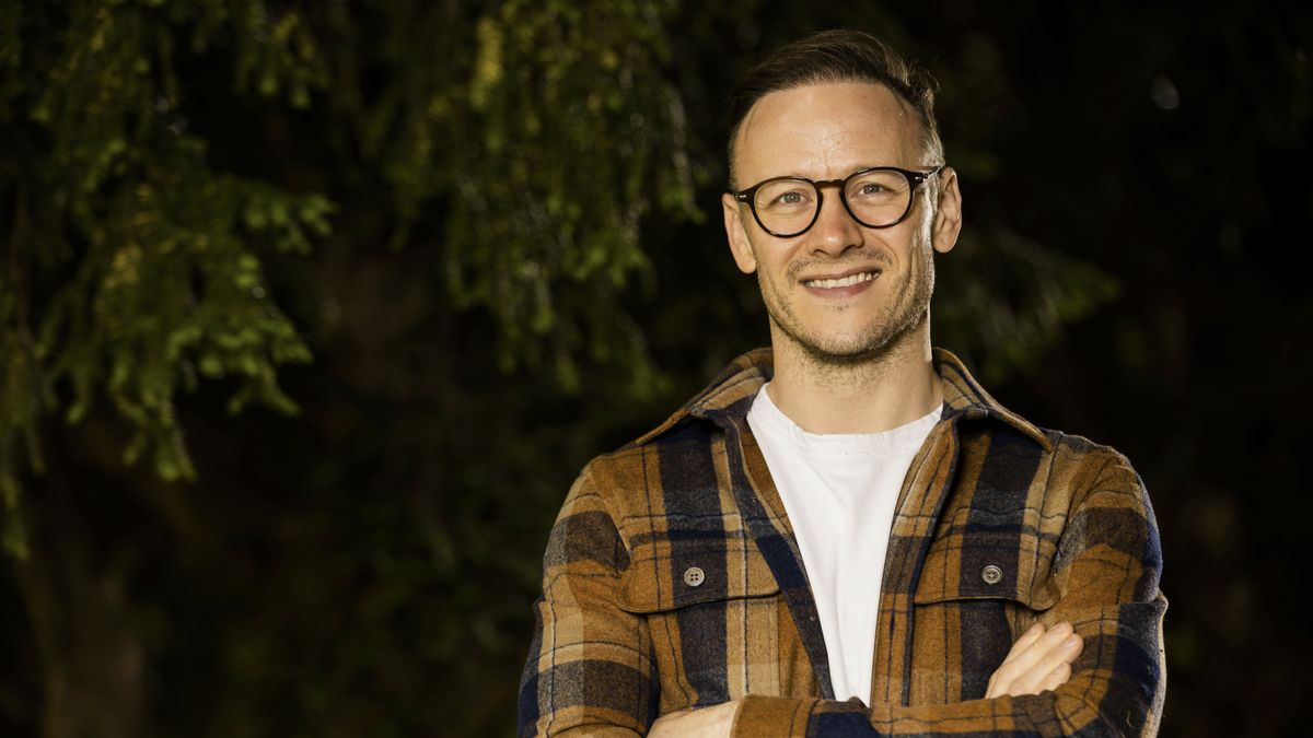 Kevin Clifton stands by a tree in Who Do You Think You Are