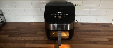 The Instant Vortex Plus 6-in-1 air fryer with ClearCook and OdourEase on a kitchen sountertop with the light illuminated