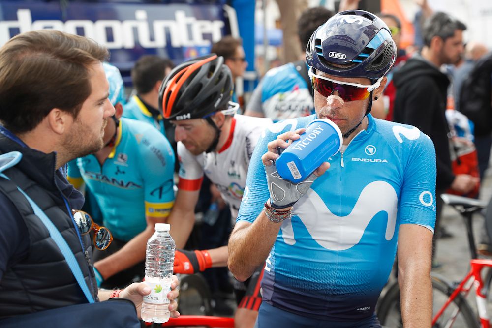 A Movistar riders gets a refreshment after the stage