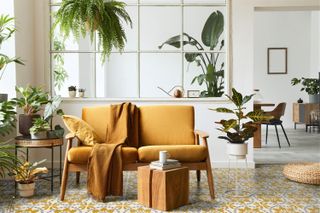 sunroom with grey and yellow patterned floor tiles and yellow sofa