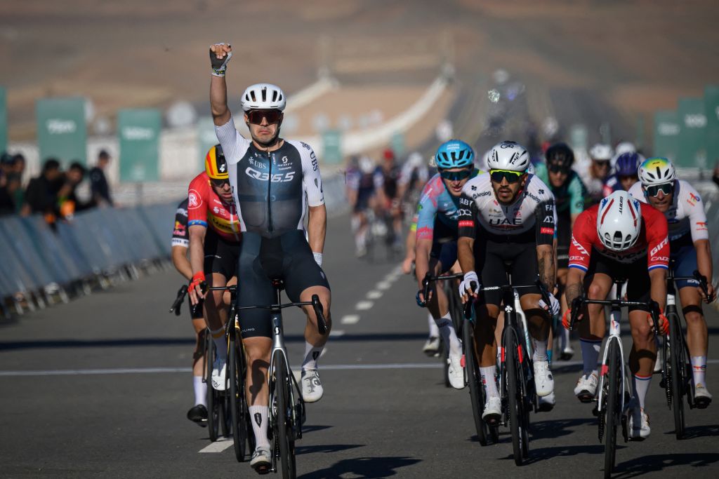 Q36.5 Pro Cycling Team's Italian rider Matteo Moschetti (L) celebrates his victory as he crosses the finish line of the fifth stage of the the Alula Tour cycling race in Alula on February 1, 2025. (Photo by Loic VENANCE / AFP)