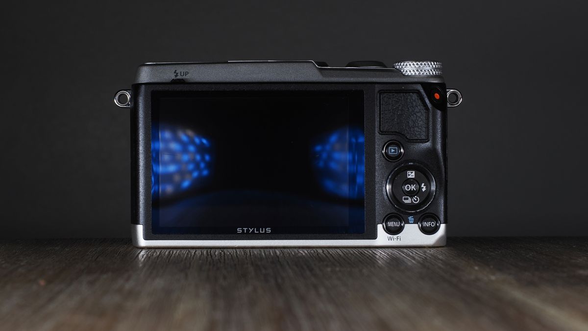 Olympus Stylus SH-3 on a wooden surface