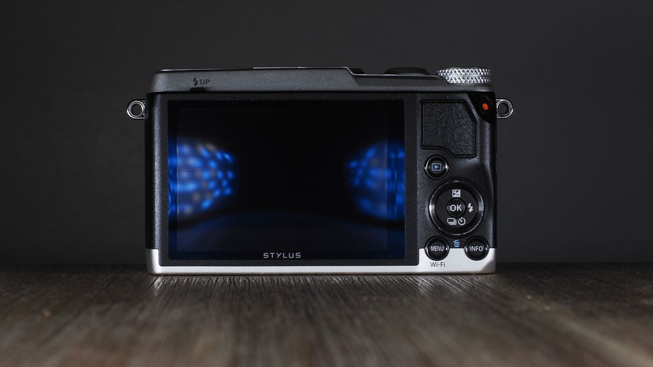 Olympus Stylus SH-3 on a wooden surface