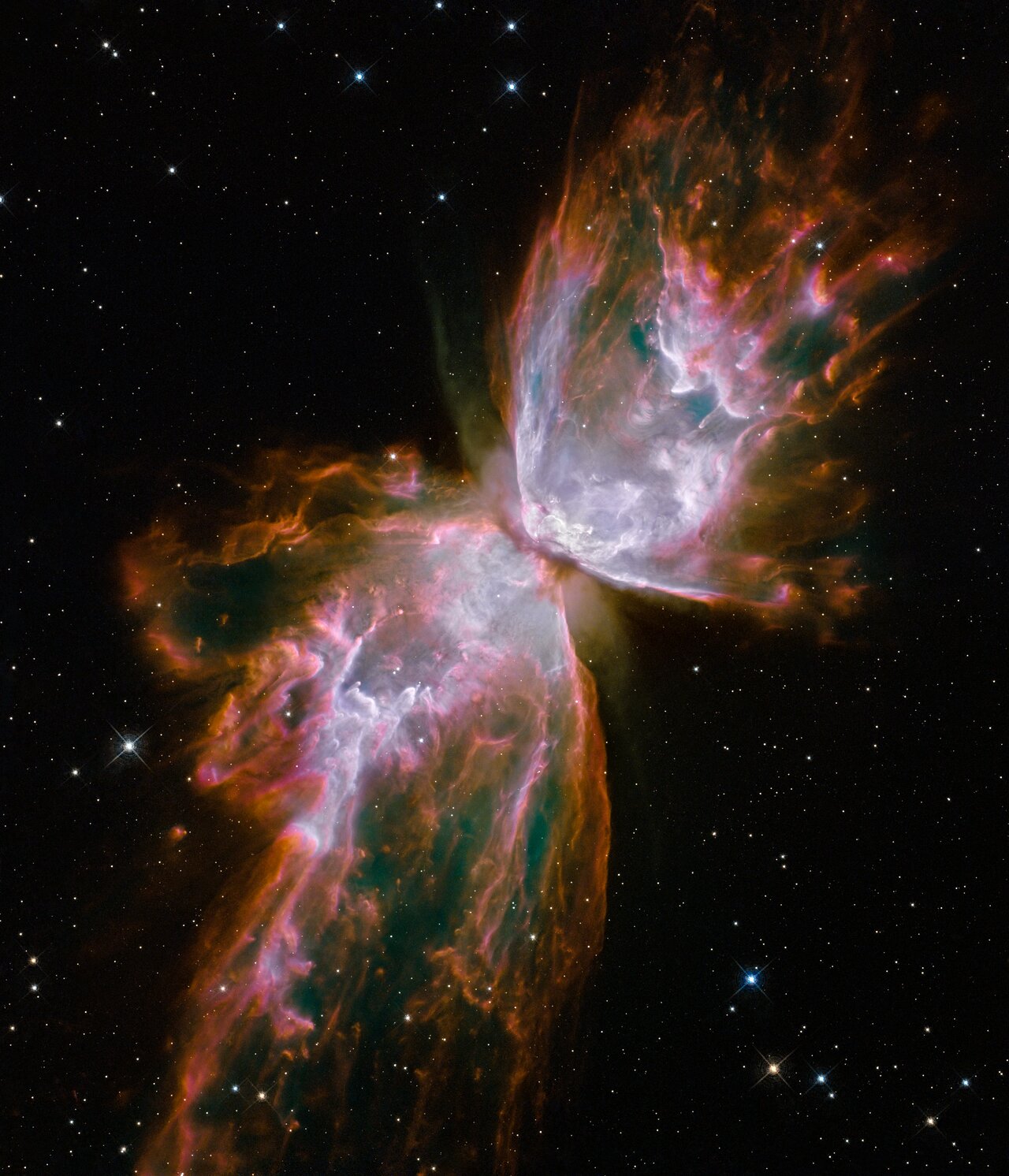 Two glowing &quot;wings&quot; of gas and dust arch outwards from a center point into the darkness of space as part of the Butterfly nebula