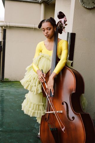 Still from Fenn O'Malley film of girl with cello in yellow dress