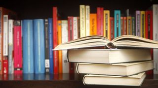 books in a pile on a bookshelf