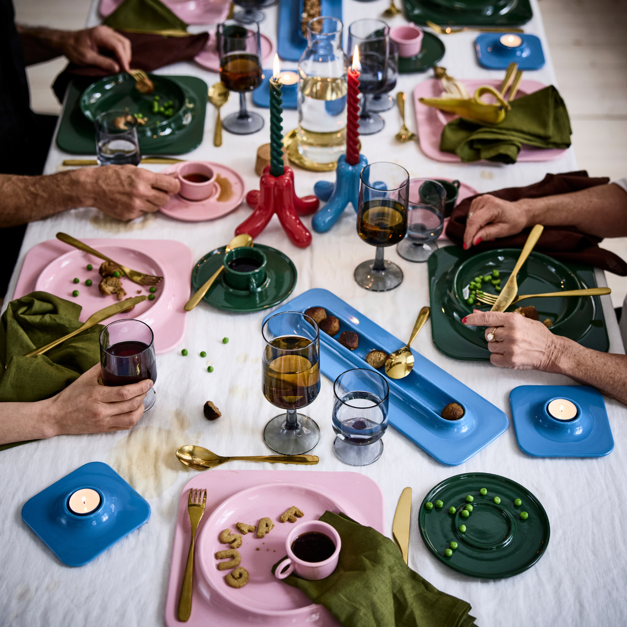 IKEA X Gustaf Westman collection on a busy dining table.