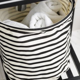 storage basket in a bathroom with towels in