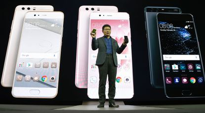 Chinese multinational networking and telecommunications equipment and services company Huawei's CEO Richard Yu presents the new phone Huawei's P10 during a press conference on February 26, 20