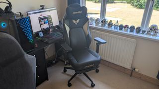 The AutoFull M6 Ultra gaming chair pictured in front of a desk with a gaming PC setup.