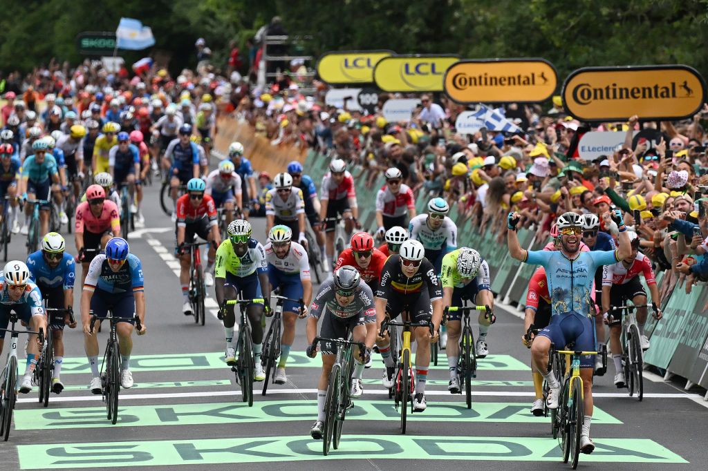 SAINT VULBAS FRANCE JULY 03 EDITORS NOTE Alternate crop Mark Cavendish of The United Kingdom and Astana Qazaqstan Team celebrates at finish line as stage winner ahead of LR Jasper Philipsen of Belgium and Team Alpecin Deceuninck and Arnaud De Lie of Belgium and Team Lotto Dstny during the 111th Tour de France 2024 Stage 5 a 1774km stage from SaintJeandeMaurienne to Saint Vulbas UCIWT on July 03 2024 in Saint Vulbas France Photo by Tim de WaeleGetty Images