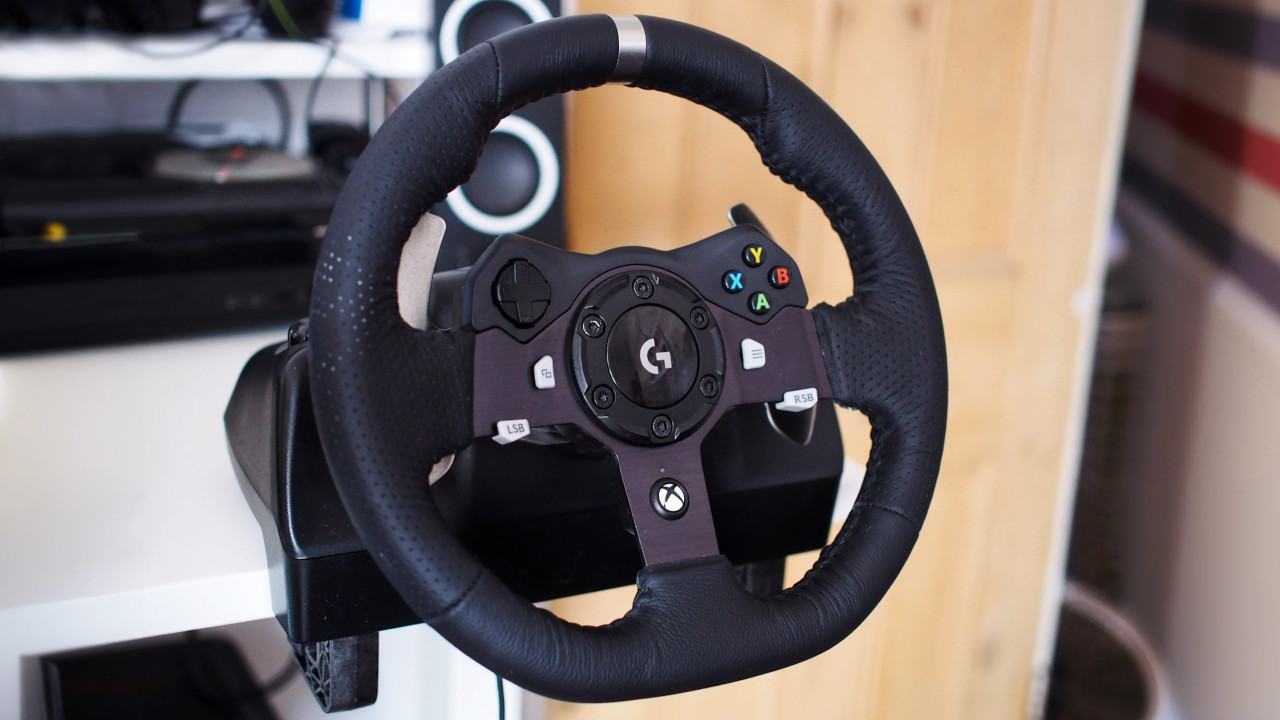Logitech G920 racing wheel attached to a computer desk