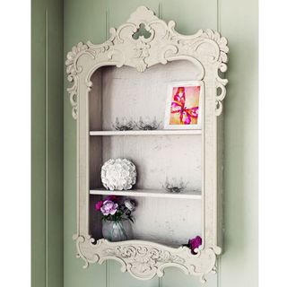 Groleau Accent Shelf with ornaments against green wall