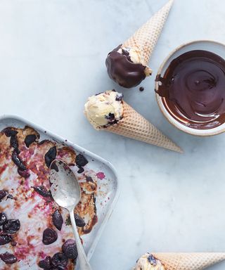 Cherry ice creams in cones with chocolate sauce and roasted cherries