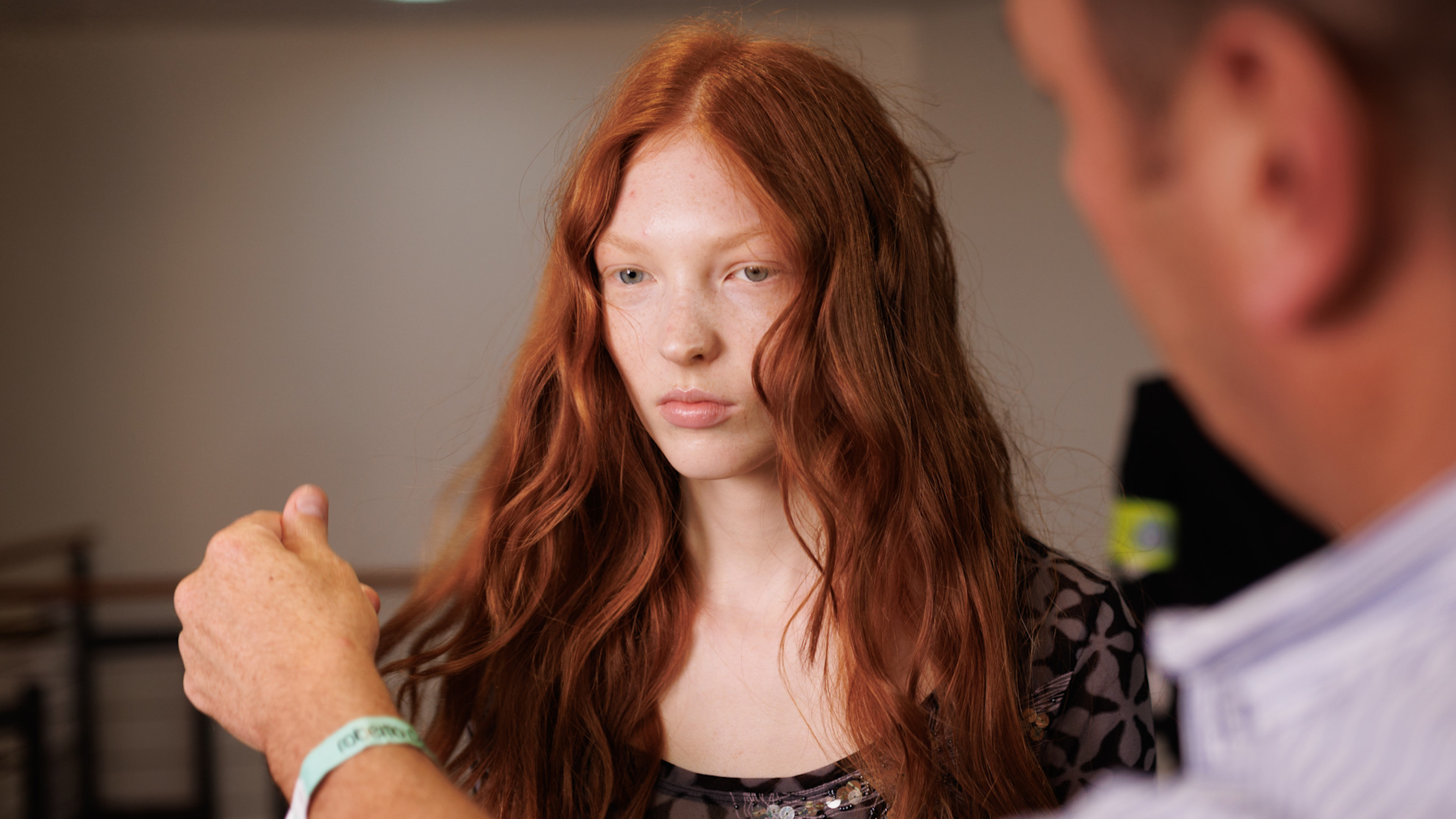 Redhead model getting her hair touched up backstage at Roberto Cavalli spring 2025 show