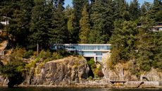 Daniel Evan White house on a craggy cliffside among woods