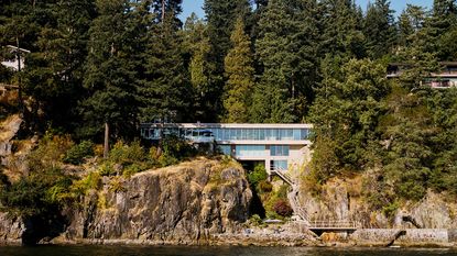 Daniel Evan White house on a craggy cliffside among woods