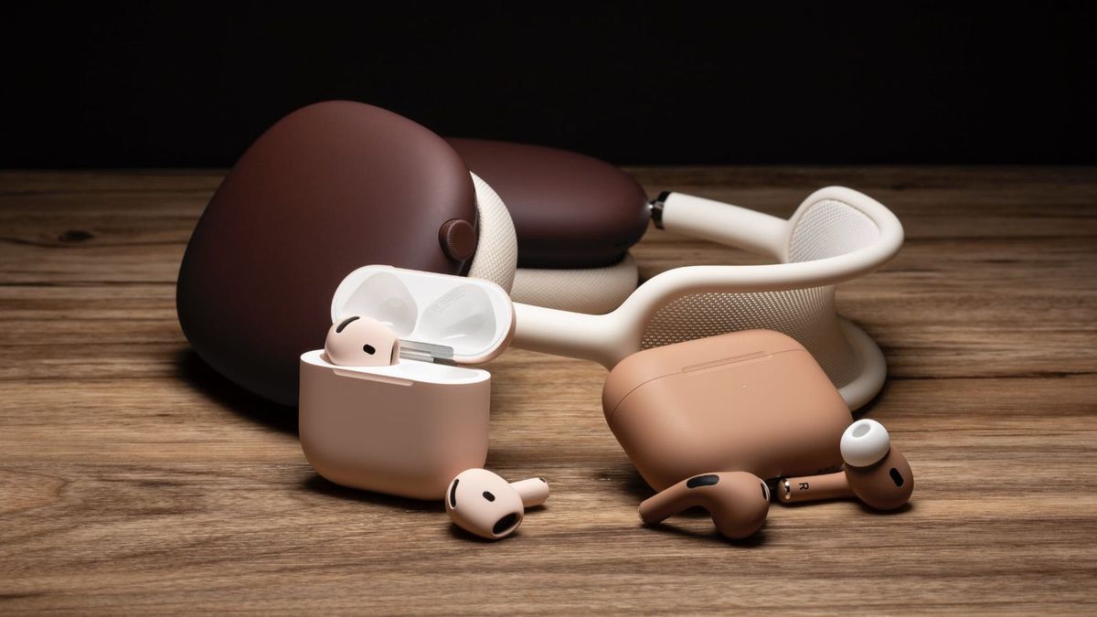 Multiple Apple AirPods models and cases, painted in light and dark brown, placed on a wooden surface.