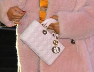 A closeup of Keke Palmer embracing the east-west bag trend with a quilted white Dior Lady D-Joy bag, a reimagining of the brand's classic Lady Dior style.