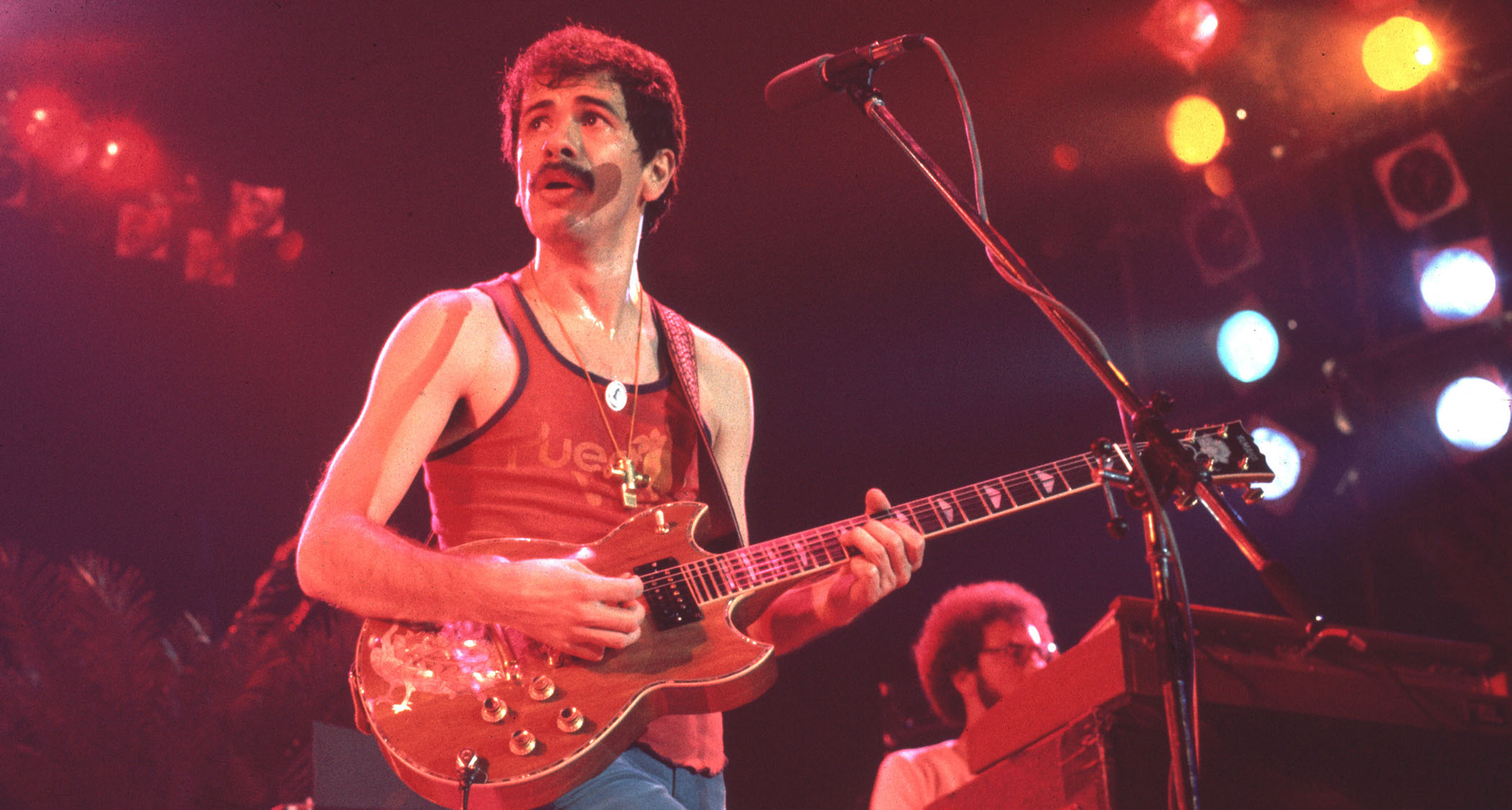 Carlos Santana plays a Yamaha electric onstage