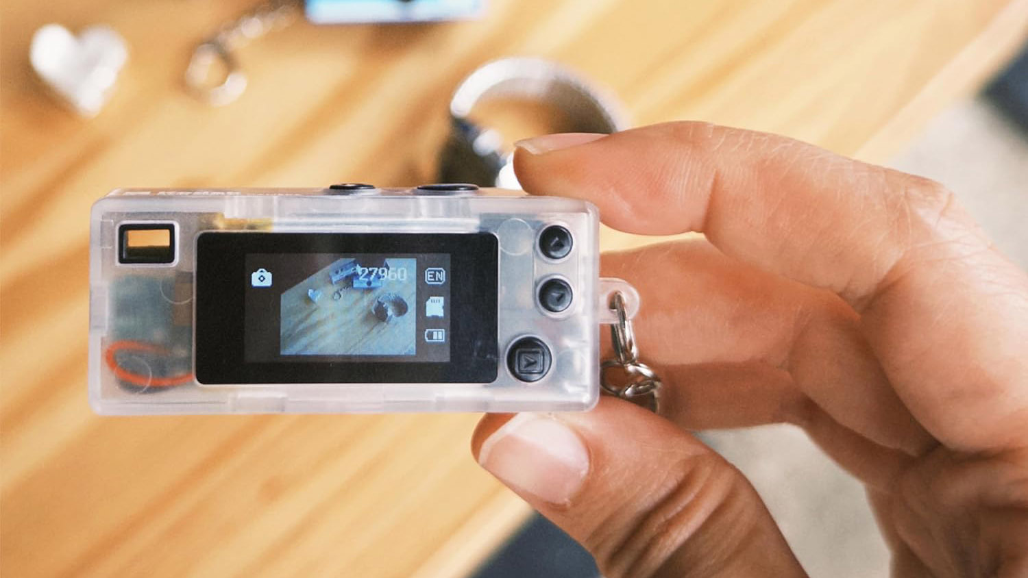 A lifestyle picture of the limited edition clear Kodak Charmera in a person's hand