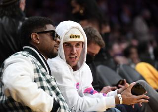 Justin Bieber and Usher attend the game between the Los Angeles Lakers and the Golden State Warriors at Staples Center on October 19, 2021.