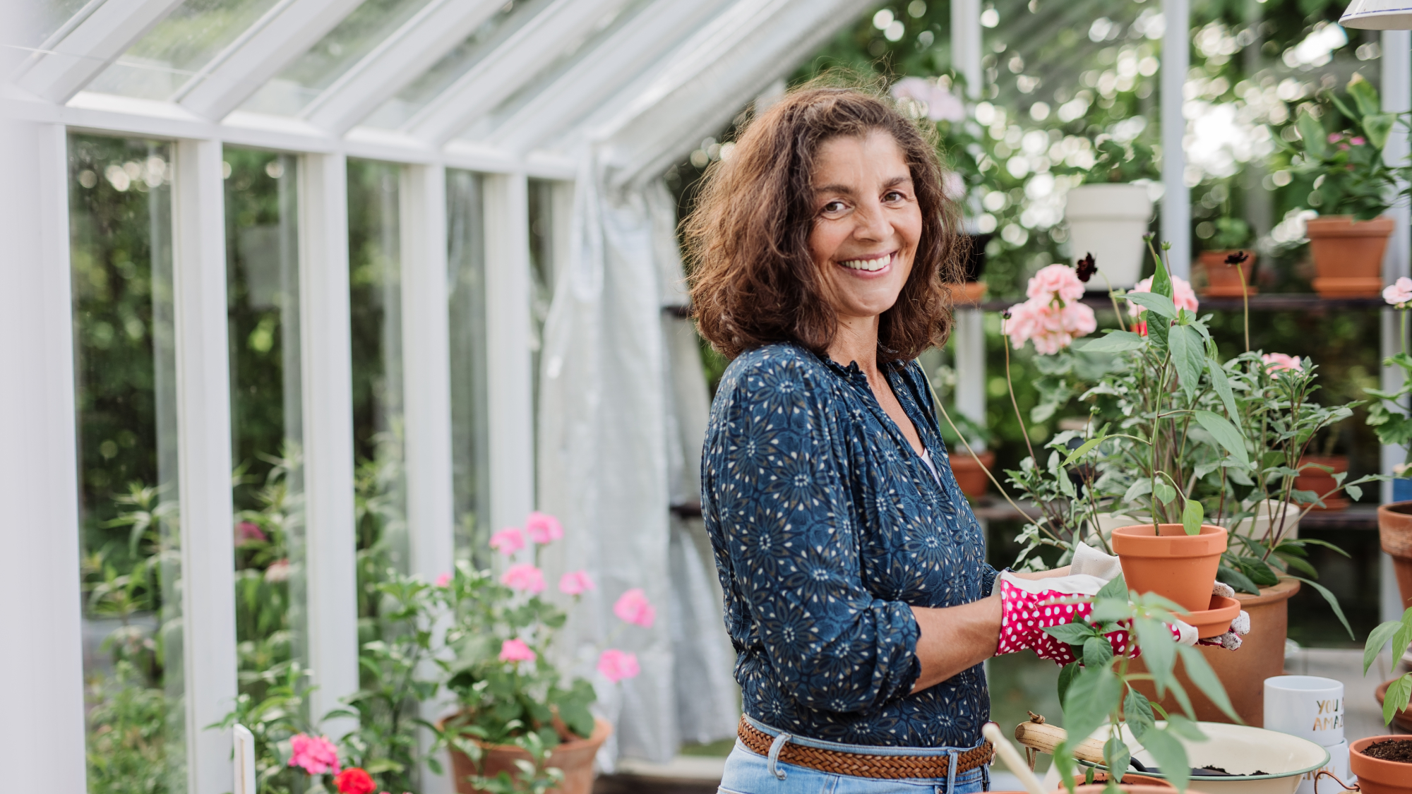 smiling woman in garden greenhouse