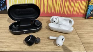 Cambridge Audio Melomania M100 vs Apple AirPods Pro 2 with one earbud out of their charging cases