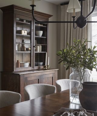 A dining room featuring a dark wooden tall sideboard