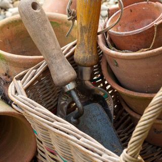 bucket with gardening tools pots and spade
