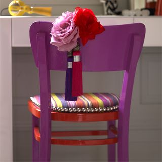 purple chair with coloured striped seat and roses