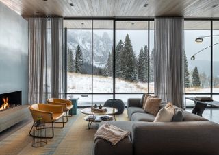 DNA Alpine living space interior with view out to snowy mountain landscape