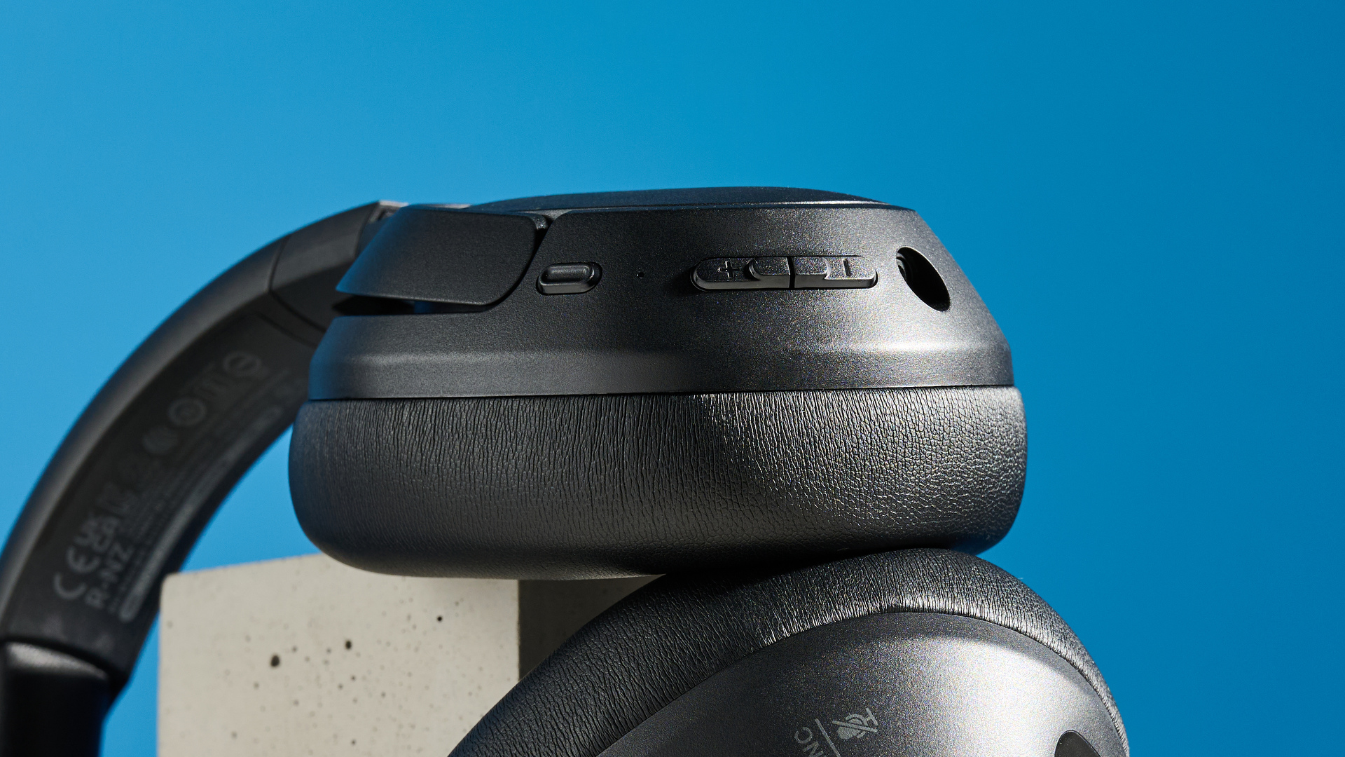 the belkin soundform isolate are a pair of budget headphones in black, with soft pillowy cups, control buttons on each cup, and ANC