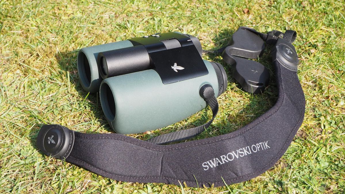 A pair of Swarovski Optik AX Visio smart binoculars, on grass.