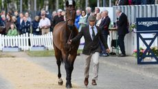 Lithuania's Aistis Vitkauskas and Commander Vg trotting towards the camera with spectators behind at the were sent to the holding box during the Luhm&uuml;hlen Horse Trials CCI5* first horse inspection.
