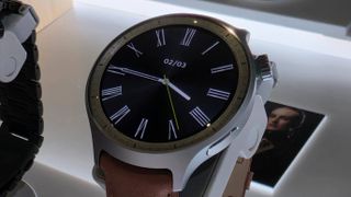 The Moto Watch on a stand.